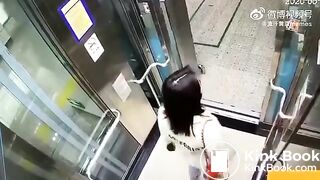 Asian woman shitting in an elevator