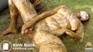 Busty babe masturbating in a bathtub full with cow shit