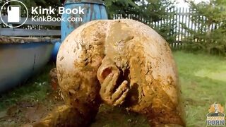 Busty babe masturbating in a bathtub full with cow shit