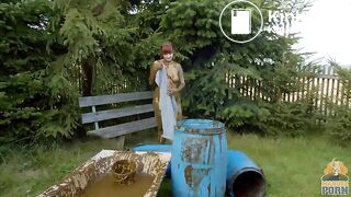 Busty babe masturbating in a bathtub full with cow shit