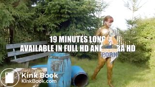 Busty babe masturbating in a bathtub full with cow shit