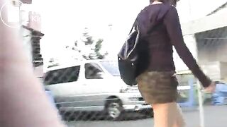 An Asian lady poops in the bushes..