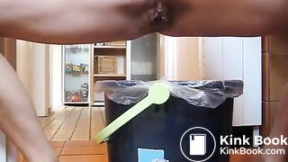 German lady defecates in a trash can..