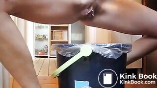 German lady defecates in a trash can..