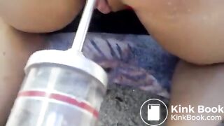 Dirty enema for the wife on the beach