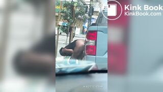 Woman shits on the street.