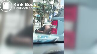 Woman shits on the street.