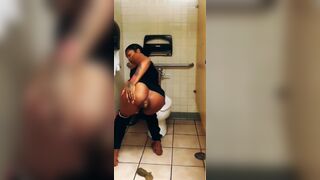 Black woman shitting on stall floor of public toilet - video 2