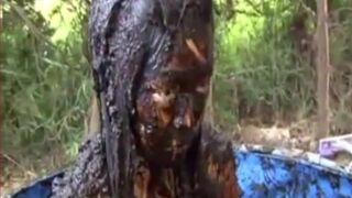 Thai girl taking a bath in cow shit.