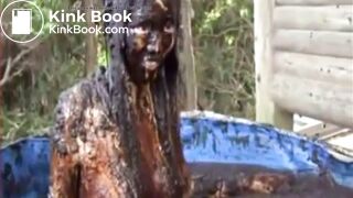 Thai girl taking a bath in cow shit.