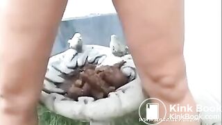 blonde girl pooping in her garden