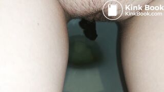 Showing hairy pussy while shitting