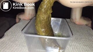 Girl shitting big turd into a plastic container