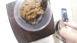 Girl fills up a container with shit