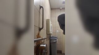 Woman has diarrhea on bathroom wall