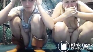 Two bitches play with water in the summer