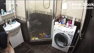 A young chick pooping in bathroom while using phone