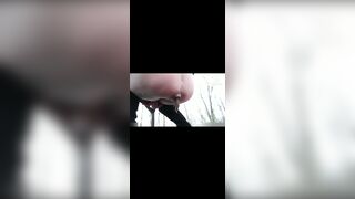 girl shit in rainy weather outdoors and her friend takes pictures on camera