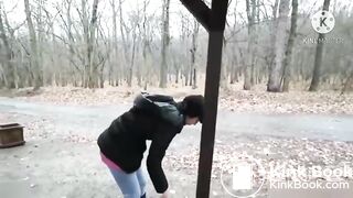 girl shit in rainy weather outdoors and her friend takes pictures on camera