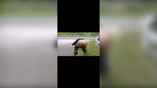 Girl in a black turtleneck poops by the road
