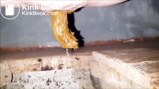 girl is pooping on outdoor toilet