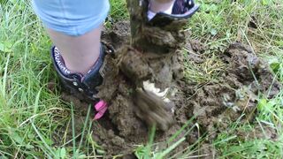 Girl trashing shoes in old cow shit