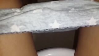 Girl having diarrhea in the toilet