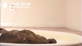 Woman shit big turd on a white plate