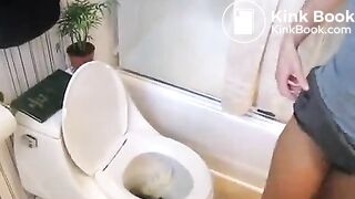 Young girl pooping in toilet.