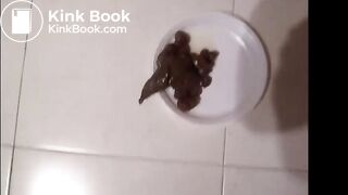 Cute Italian girl is pooping big hard logs in a white plate on the floor