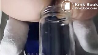 Woman pooping into jar.1