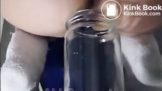 Woman pooping into jar.1
