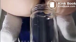 Woman pooping into jar.1