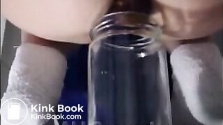 Woman pooping into jar.1