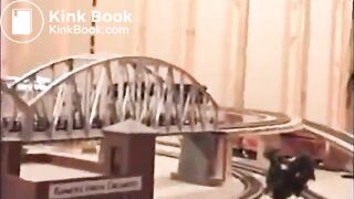 Girl shitting on a model train