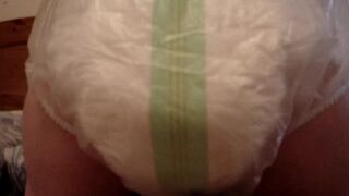 Mature woman pooping and peeing in her large diaper