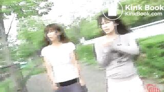 Two girls spray enema outside