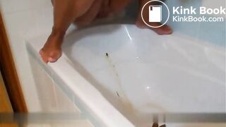 Blonde shitting and pissing inside the bathtub