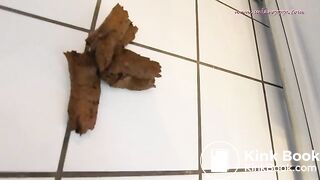 Woman pooping in ftont of the fridge