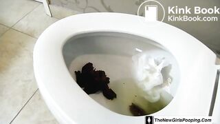 Girl shitting on the toilet