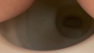Girl shitting into toilet