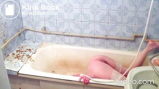 A beautiful girl in the bathroom gives herself an enema