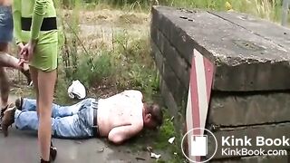 Three women pissing and shitting on a guy outdoors
