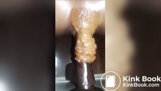 Girl pooping on anal dildo