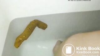 constipated asian girl pushes out huge shit in the tub