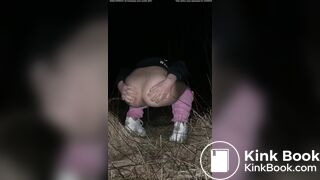 Girl pooping at night in the field