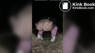 Girl pooping at night in the field