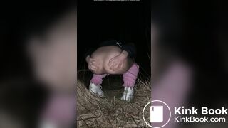 Girl pooping at night in the field