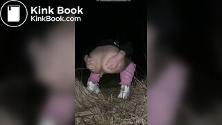 Girl pooping at night in the field