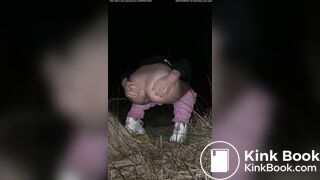 Girl pooping at night in the field